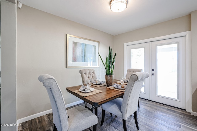 dining room featuring french doors and dark wood-type flooring