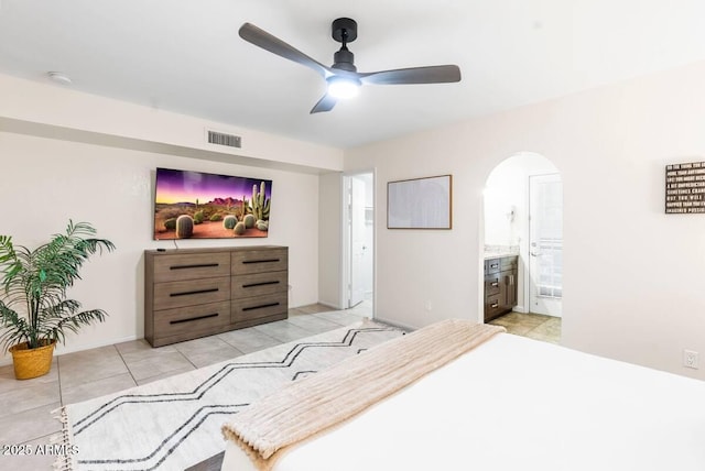 16436 N 64th Pl, Scottsdale, AZ 85254 - bedroom featuring arched walkways, light tile patterned floors, ensuite bath, and ceiling fan