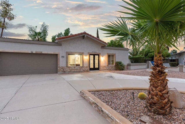 16436 N 64th Pl, Scottsdale, AZ 85254 - mediterranean / spanish-style home with stucco siding, a tiled roof, and stone siding