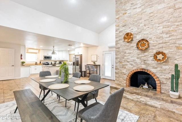 16436 N 64th Pl, Scottsdale, AZ 85254 - dining space featuring high vaulted ceiling, a fireplace, light tile patterned floors, and a wall unit AC