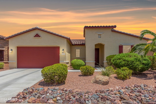 mediterranean / spanish-style home with a garage