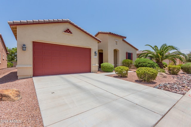 mediterranean / spanish-style house featuring a garage