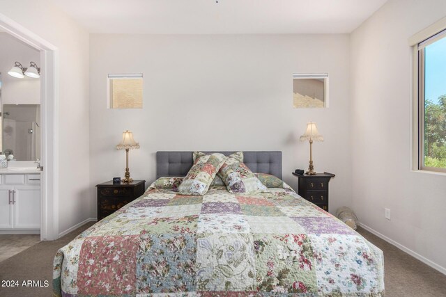 bedroom with carpet floors and ensuite bath