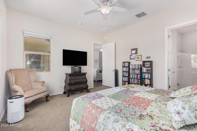 bedroom featuring ensuite bathroom, carpet floors, and ceiling fan