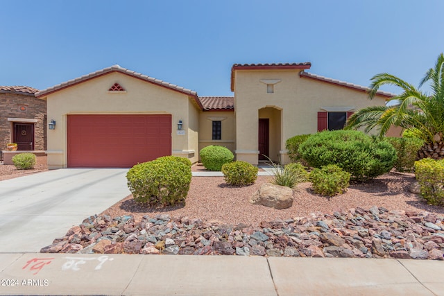 mediterranean / spanish-style home with a garage