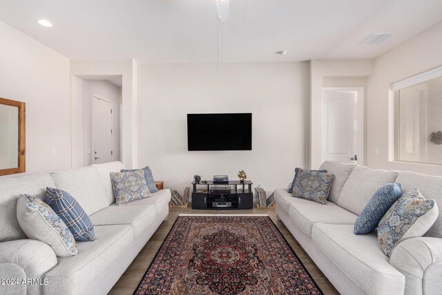 living room featuring ceiling fan and hardwood / wood-style floors