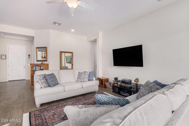 living room featuring hardwood / wood-style floors and ceiling fan