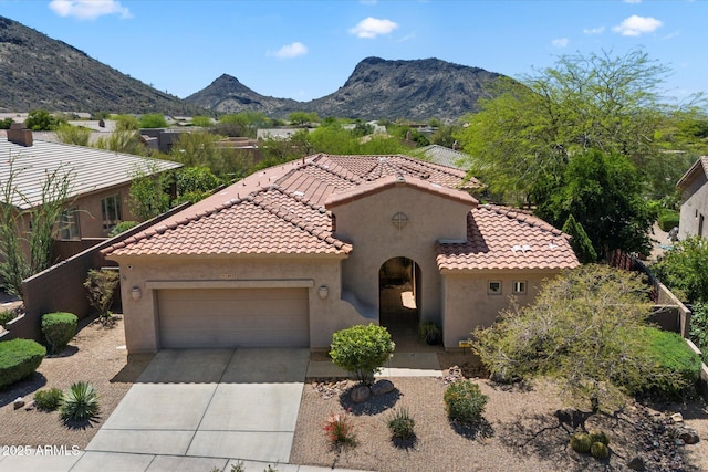 14037 E Coyote Rd, Scottsdale, AZ 85259 - mediterranean / spanish-style home featuring concrete driveway, stucco siding, a mountain view, a garage, and a tiled roof
