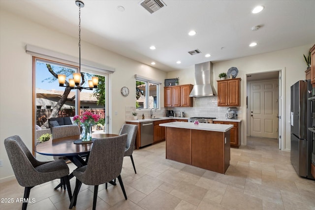 14037 E Coyote Rd, Scottsdale, AZ 85259 - kitchen featuring a sink, wall chimney range hood, visible vents, and stainless steel appliances
