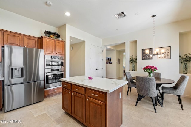14037 E Coyote Rd, Scottsdale, AZ 85259 - kitchen featuring visible vents, decorative light fixtures, an inviting chandelier, appliances with stainless steel finishes, and a kitchen island