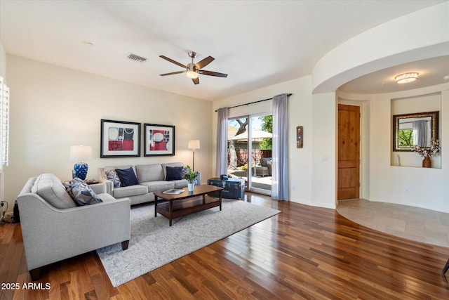 14037 E Coyote Rd, Scottsdale, AZ 85259 - living room with arched walkways, visible vents, a ceiling fan, and wood finished floors