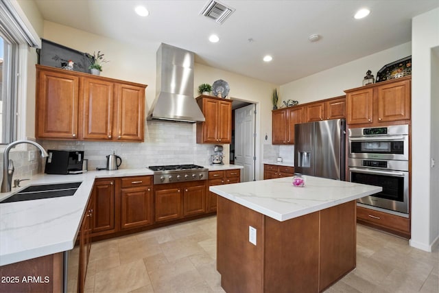 14037 E Coyote Rd, Scottsdale, AZ 85259 - kitchen with wall chimney range hood, visible vents, a center island, a sink, and stainless steel appliances