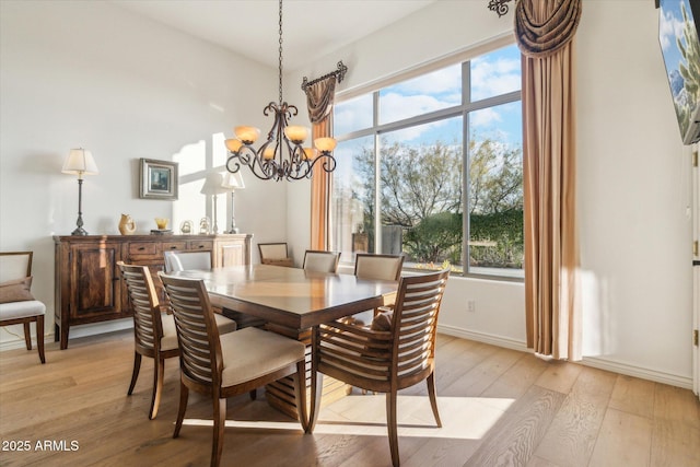 dining room featuring an inviting chandelier and light hardwood / wood-style flooring