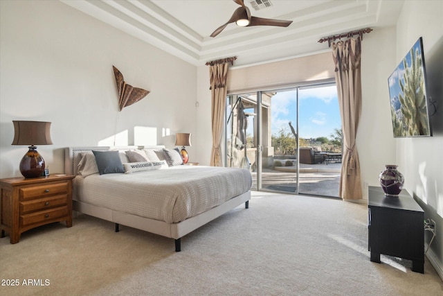 carpeted bedroom with access to outside, ceiling fan, and a tray ceiling