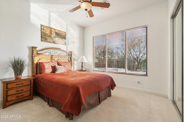 bedroom with ceiling fan, a closet, and light carpet