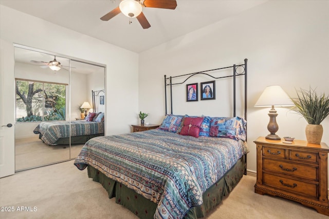 bedroom with light carpet, a closet, and ceiling fan