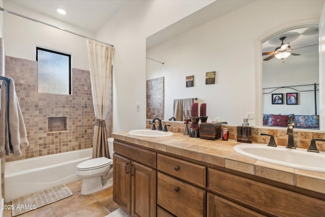 full bathroom featuring tile patterned flooring, vanity, shower / tub combo, ceiling fan, and toilet