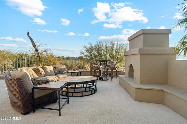 view of patio featuring an outdoor living space with a fireplace