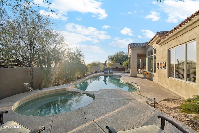 view of pool featuring an in ground hot tub and a patio