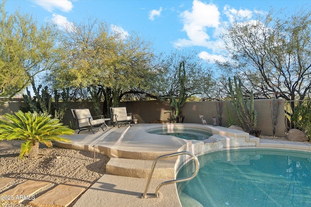 view of swimming pool with an in ground hot tub