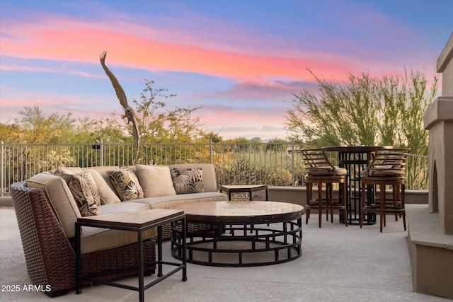 patio terrace at dusk featuring an outdoor living space