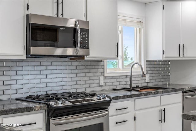 118 S 700th St E, Taylor, AZ 85939 - kitchen featuring stainless steel appliances, a sink, white cabinets, and backsplash