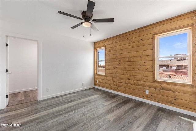118 S 700th St E, Taylor, AZ 85939 - empty room featuring plenty of natural light, ceiling fan, baseboards, wood finished floors, and wooden walls