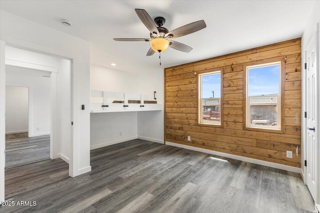 118 S 700th St E, Taylor, AZ 85939 - spare room featuring a ceiling fan, dark wood finished floors, baseboards, wood walls, and a smoke detector