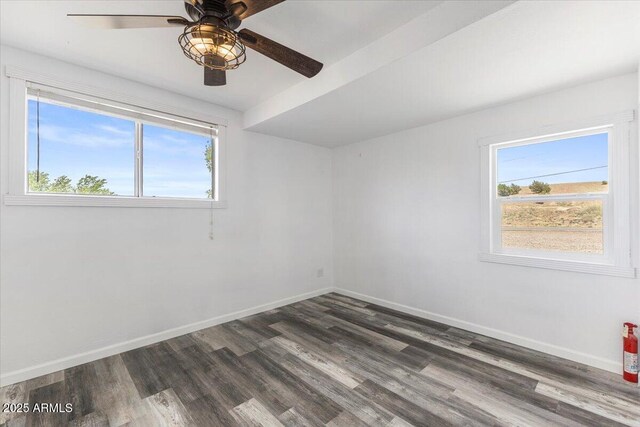 118 S 700th St E, Taylor, AZ 85939 - unfurnished room featuring dark wood-style flooring, ceiling fan, and healthy amount of natural light