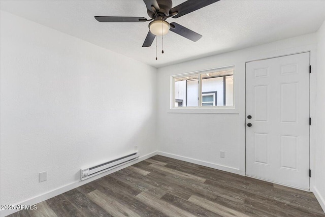 118 S 700th St E, Taylor, AZ 85939 - unfurnished room featuring baseboard heating, dark wood-style flooring, ceiling fan, and baseboards