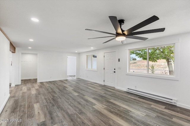118 S 700th St E, Taylor, AZ 85939 - unfurnished living room with a baseboard heating unit, ceiling fan, wood finished floors, recessed lighting, and baseboards
