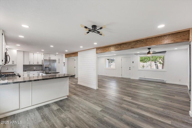118 S 700th St E, Taylor, AZ 85939 - kitchen featuring appliances with stainless steel finishes, a baseboard heating unit, recessed lighting, open floor plan, and a peninsula