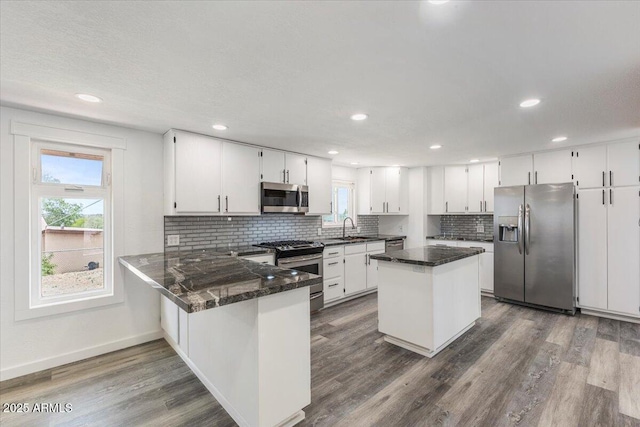 118 S 700th St E, Taylor, AZ 85939 - kitchen featuring stainless steel appliances, backsplash, baseboards, dark wood-type flooring, and white cabinets