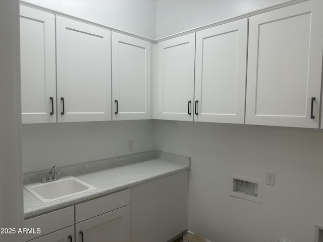 laundry area featuring a sink, cabinet space, and washer hookup