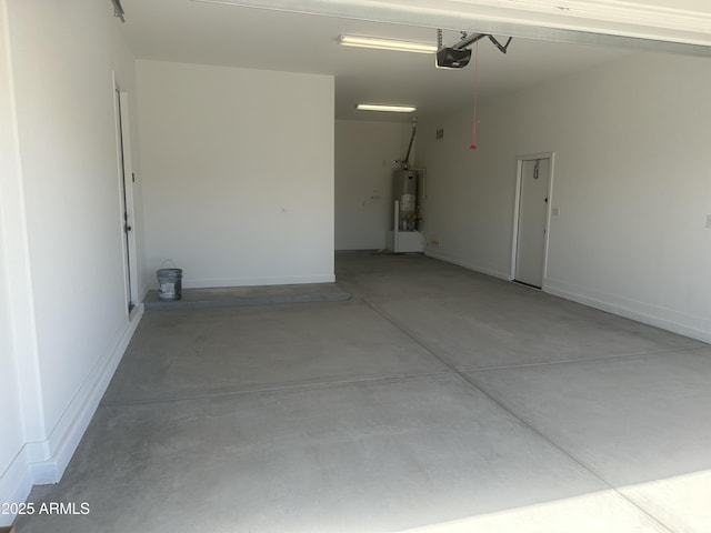 garage with a garage door opener, baseboards, and gas water heater