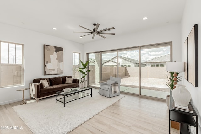 living room featuring a wealth of natural light, wood finished floors, recessed lighting, and a ceiling fan