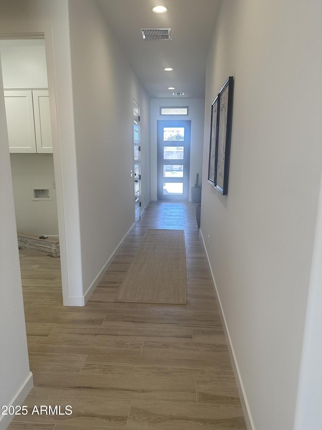 hallway with recessed lighting, baseboards, light wood finished floors, and visible vents
