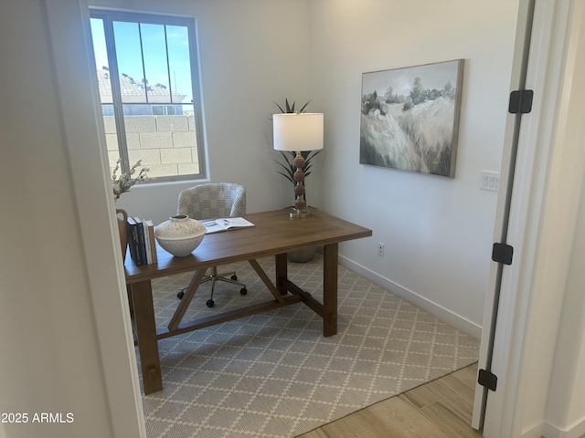 office area with baseboards and wood finished floors