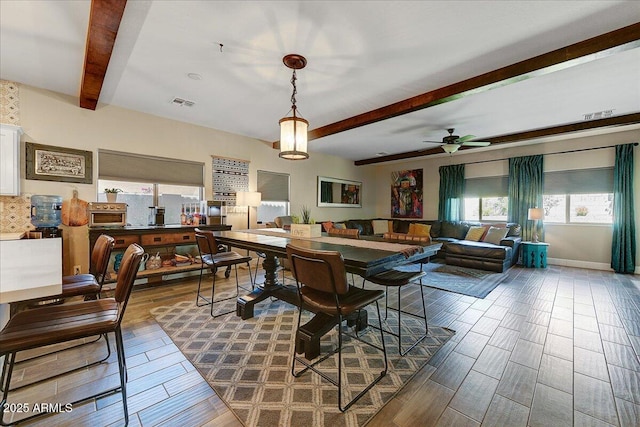 dining room featuring ceiling fan, beam ceiling, and visible vents
