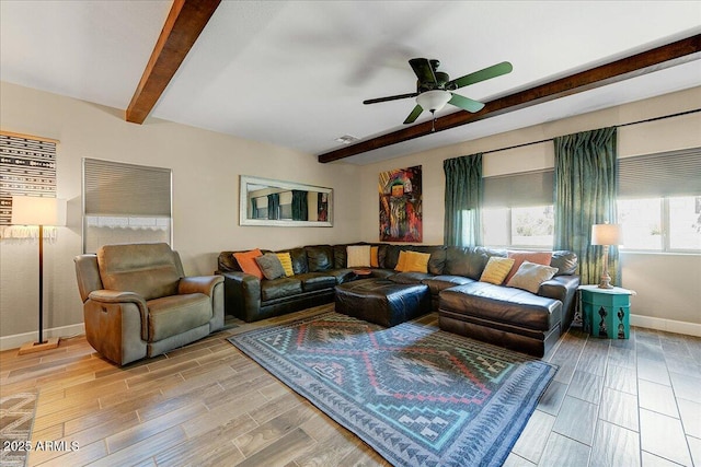 living area with ceiling fan, visible vents, baseboards, beamed ceiling, and light wood finished floors