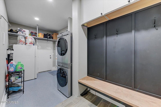 clothes washing area with laundry area and stacked washer / dryer