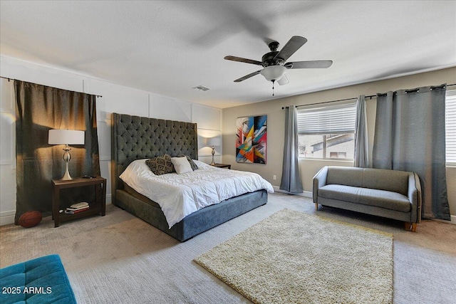 carpeted bedroom with visible vents and a ceiling fan