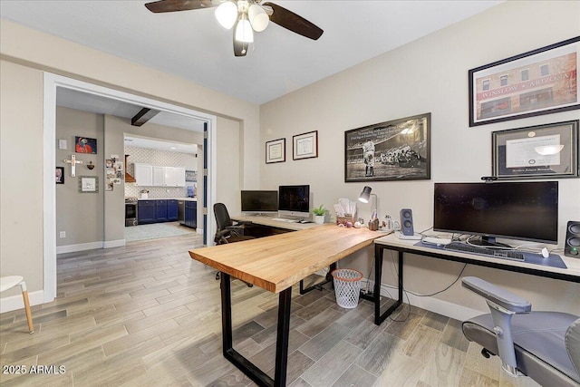 office area with a ceiling fan, baseboards, and light wood-style floors