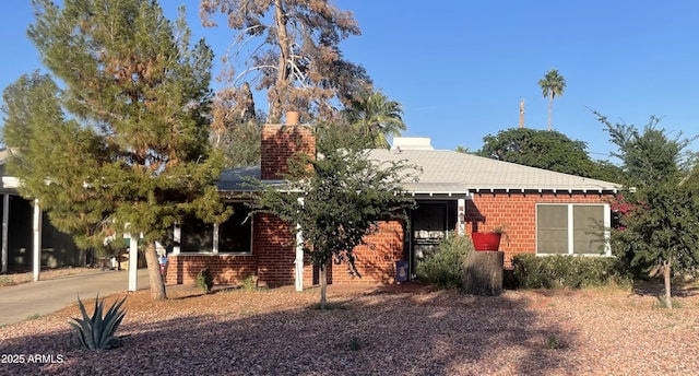 3115 N 26th St, Phoenix, AZ 85016 - view of front of house with brick siding, a chimney, and a shingled roof