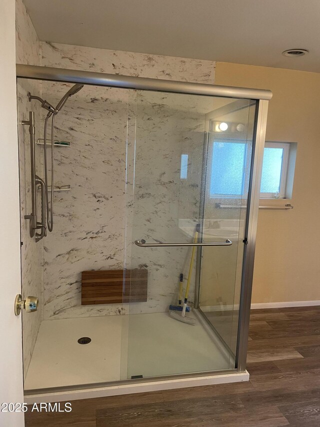 3115 N 26th St, Phoenix, AZ 85016 - bathroom featuring a marble finish shower, wood finished floors, and baseboards