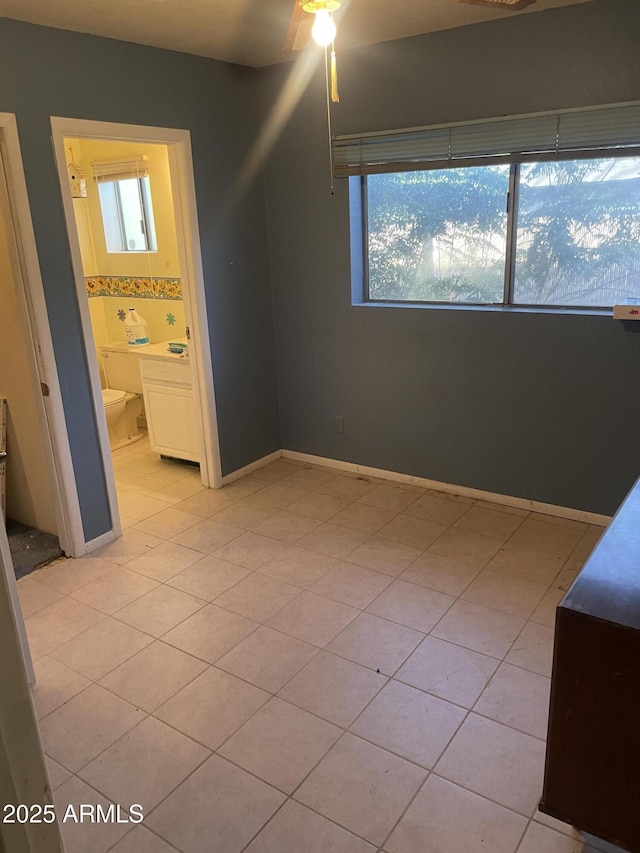 3115 N 26th St, Phoenix, AZ 85016 - unfurnished bedroom featuring light tile patterned floors, connected bathroom, and ceiling fan
