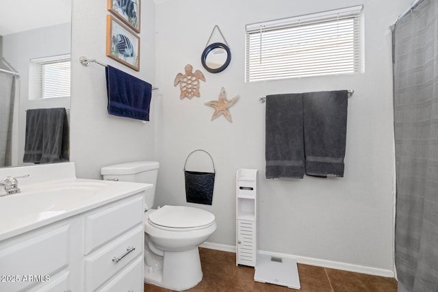 bathroom with toilet, tile patterned floors, and vanity