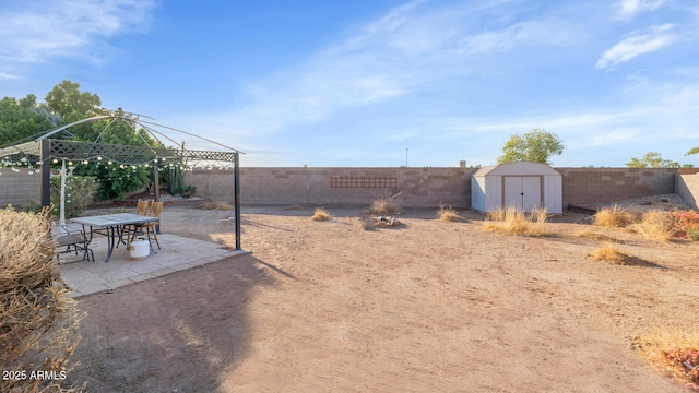 view of yard with a shed, a gazebo, and a patio