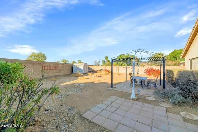 view of patio / terrace featuring a gazebo and a storage shed