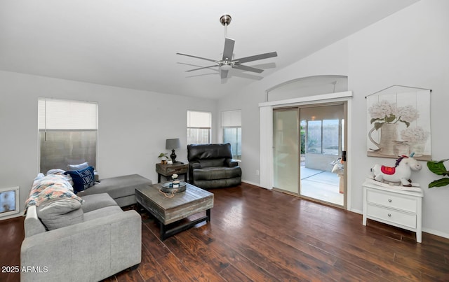 living room featuring ceiling fan, vaulted ceiling, and dark wood-type flooring